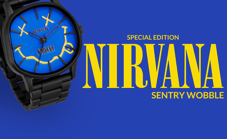 A black Nixon watch with a blue face featuring the yellow Nirvana smiley logo and text is displayed next to yellow text on a blue background that reads "SPECIAL EDITION NIRVANA SENTRY WOBBLE".