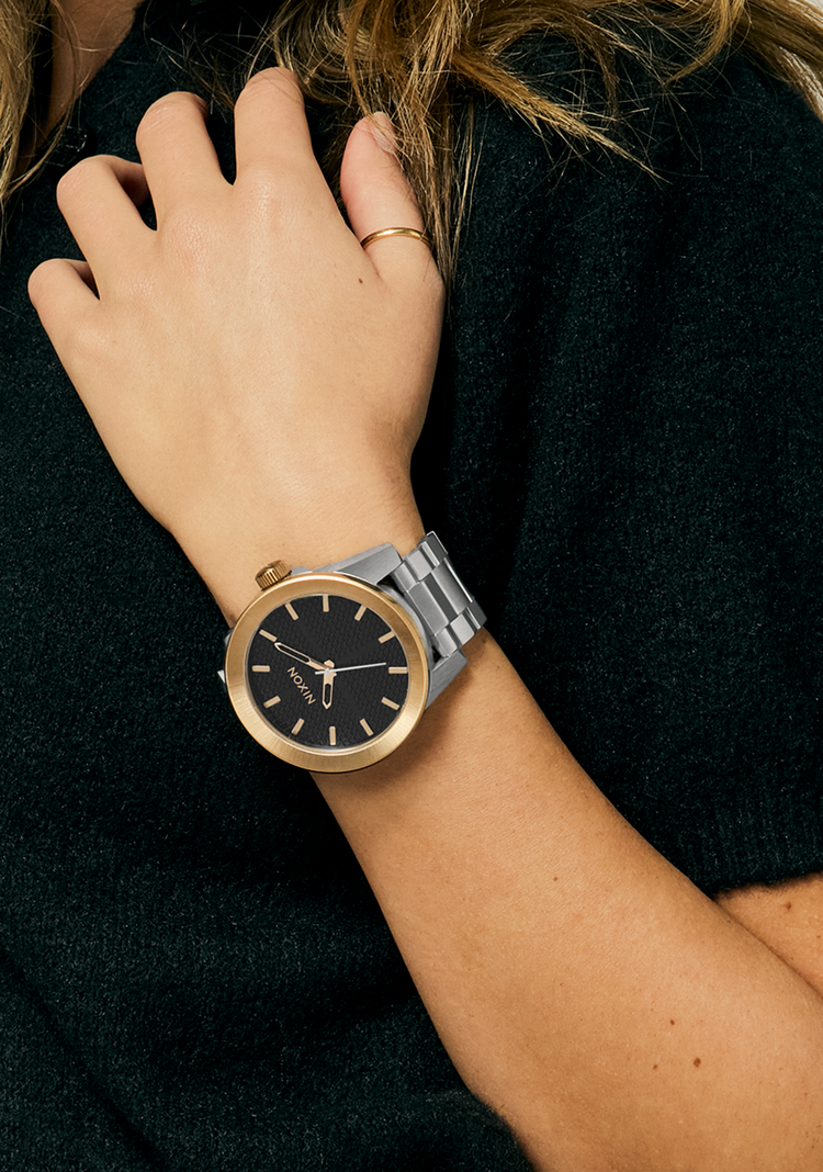 Woman wearing a silver Nixon Corporal analog watch